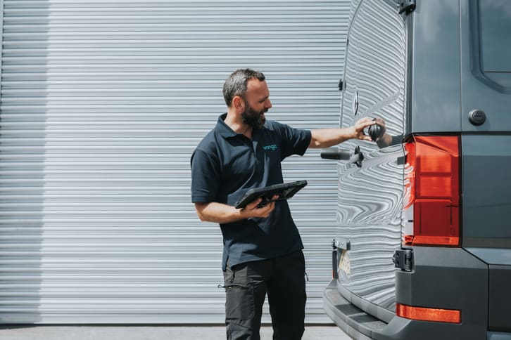 A Vangoo inspector checking a van’s rear lights