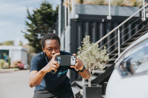 A Vangoo inspector photographing a vehicle